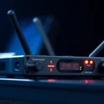 Close-up of the PG88 wireless receiver showing signal lights and controls for professional audio setup, highlighting reliability and clarity.